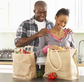Couple in Kitchen with Groceries